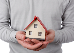 Man holding house